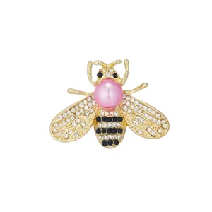 Exquisite rhinestone bee brooch with pink pearl detail, elegant fashion jewelry accessory.