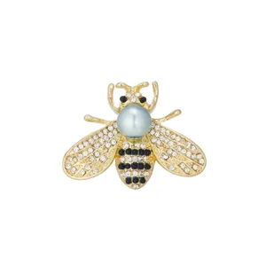 Exquisite bee brooch detail shot, featuring sparkling rhinestones and elegant faux pearl design.