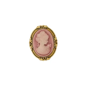 Close-up detail of a retro cameo brooch featuring an elegant vintage portrait and intricate gold frame.
