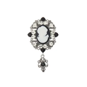 Vintage medieval cameo brooch with crystal rhinestones and silver filigree pendant.