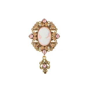 Exquisite vintage cameo brooch with sparkling rhinestones and ornate gold frame detail.