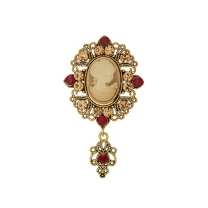 Vintage medieval cameo brooch detail, gold-tone filigree setting with rhinestones and drop.