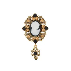 Vintage Victorian cameo brooch with ornate gold filigree, sparkling rhinestones and elegant profile.
