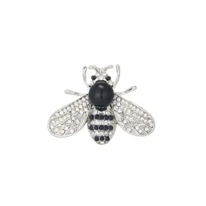 Close-up detail of silver tone rhinestone bee brooch with sparkling crystal accents.