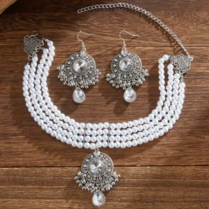 Detailed view of vintage multi-layer faux pearl rhinestone necklace and matching earrings set.