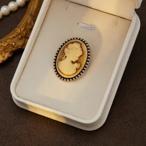 Detailed closeup of vintage cameo portrait brooch, elegant court style jewelry design.