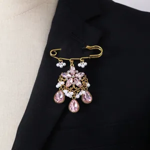 Gold-tone safety pin brooch with pink crystal rhinestones and faux pearls detail shot.