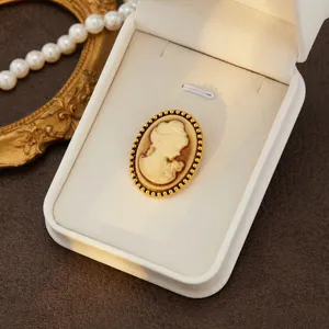 Vintage cameo brooch featuring an elegant lady portrait with a sophisticated gold beaded border.