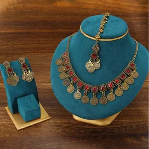 Bohemian vintage antique gold jewelry set with red stones, necklace, earrings, and tikka.