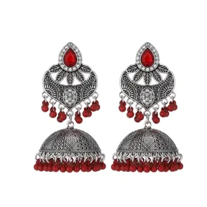 Exquisite detail view of Indian ethnic silver jhumka earrings featuring striking red beads.