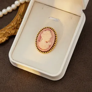 Vintage cameo brooch detail, elegant Victorian style oval relief pin with golden beaded rim.