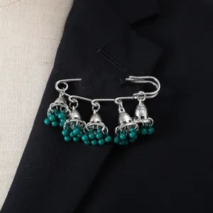 Vintage ethnic style bell tassel brooch pin with green beads, elegant detail showcase.