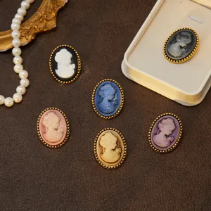 Close-up of vintage cameo portrait brooches with elegant gold beaded borders for chic fashion styling.