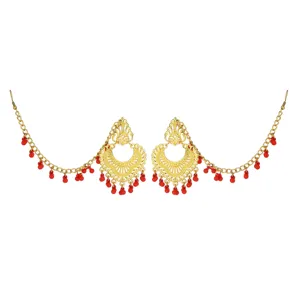 Detailed close-up of Indian ethnic gold-plated earrings with vibrant red beads and delicate filigree.