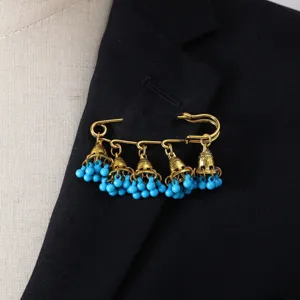 Vintage bohemian bell tassel brooch detail, gold tone pin with blue beaded charms accessory.