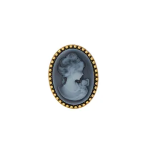 Vintage cameo brooch detail, elegant classical portrait design in golden beaded oval frame.