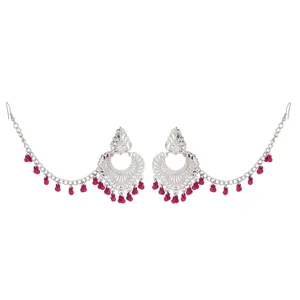 Intricate silver ethnic ear chain detail with vibrant pink dangling beads and carving.