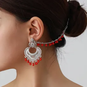 Detailed view of vintage ethnic silver-plated filigree ear chain earring with red beaded fringe.