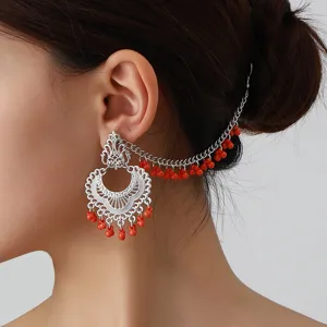 Ethnic carved ear chain with red beaded tassel, elegant vintage silver drop earrings for women.