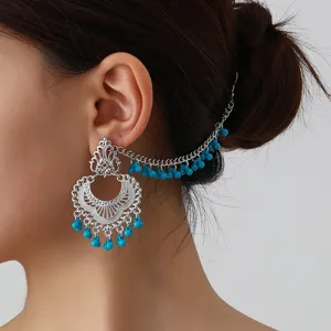 Ethnic style silver tone filigree chain tassel earrings with blue beads detail view