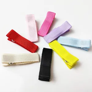 Colorful grosgrain ribbon hair clips detail view, showing neat arrangement and vibrant candy colors.