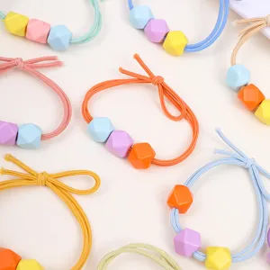 Colorful geometric bead hair ties detail, vibrant candy color elastic bands for kids hair.