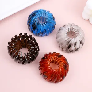 Close-up detail of expandable bird nest hair clips in multiple colors for stylish buns.