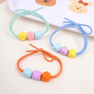 Detailed close-up of Korean candy color geometric hair ties with cute multi-faceted beads for kids.