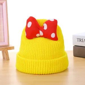 Children's cute yellow knitted beanie hat with red polka dot bow for autumn and winter warmth.