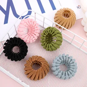 Detail view of velvet bird nest hair clips, perfect for elegant buns and ponytails.