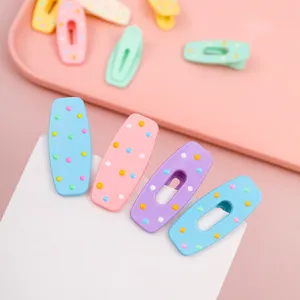 Close up of colorful macaron hair clips with polka dots, cute hair accessories for daily style.