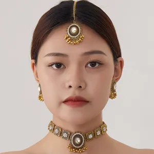 Indian retro style golden choker necklace earrings and maang tikka jewelry set for women.
