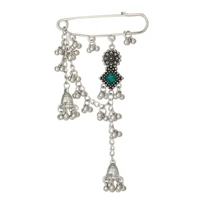 Vintage bohemian silver safety pin brooch with green rhinestone, chains and bells details.