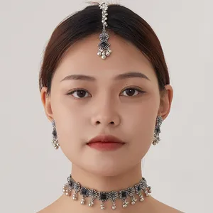 Detail shot of the ethnic vintage silver jewelry set featuring a chic choker, earrings and tikka.