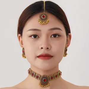 Exquisite vintage Indian jewelry set featuring intricate gold choker, earrings and maang tikka.
