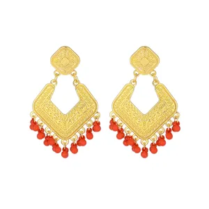 Vintage gold-toned geometric drop earrings featuring delicate filigree and vibrant red beads.