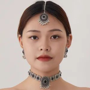 Vintage Indian ethnic jewelry set including choker necklace, earrings, and maang tikka.