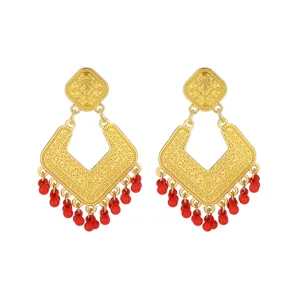 Close-up detail of vintage gold geometric dangle earrings featuring vibrant red beaded fringe.