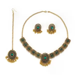 Detailed close-up view of vintage Indian green stone necklace and earrings jewelry set.