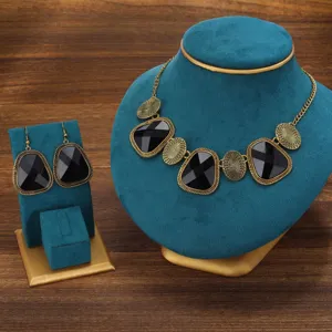Detailed view of vintage ethnic style black stone necklace and matching earrings set display.