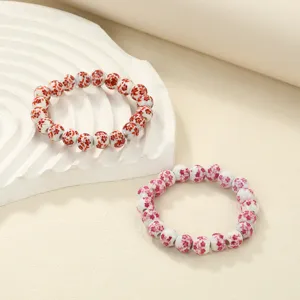 Ceramic beaded bracelet with delicate floral print, elegant daily wrist jewelry detail view.