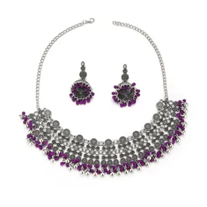 Close-up detail of bohemian ethnic silver alloy necklace and purple beaded tassel earrings set.