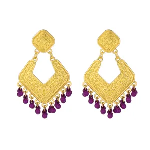 Close-up of vintage gold-toned drop earrings featuring intricate filigree and purple beaded fringe.