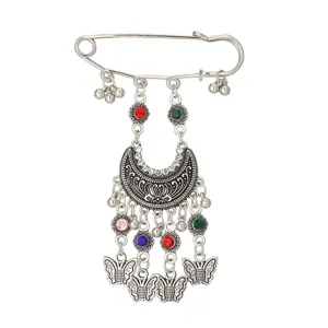 Detailed view of bohemian vintage rhinestone carved safety pin brooch with cute tassels.