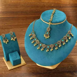 Ethnic boho jewelry set detail view showcasing necklace, earrings and maang tikka pieces.