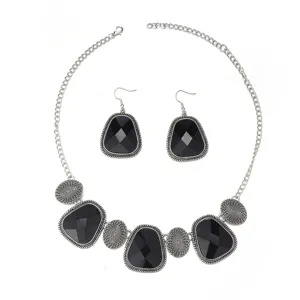 Vintage silver black stone necklace and earrings jewelry set detailed close-up display.