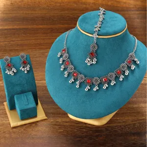 Detailed view of bohemian ethnic style silver tone red crystal necklace earrings jewelry set
