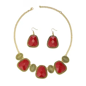 Detailed view of vintage style red gemstone necklace and matching earrings jewelry set.