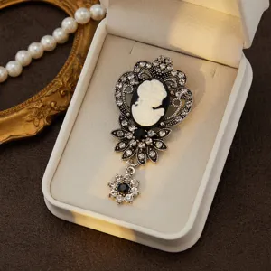 Exquisite vintage cameo rhinestone brooch detail, elegant silver tone filigree pin for women.