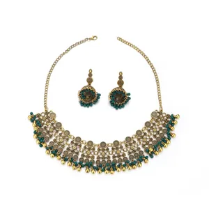 Detailed view of traditional ethnic boho gold alloy statement necklace and jhumka earrings.